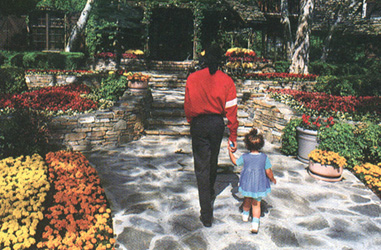 walking in a flower garden with a little girl