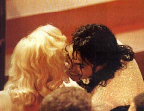 Mike and Madonna sharing a secret at some awards ceremony