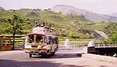 A typical painted bus winding its way up the mountains.