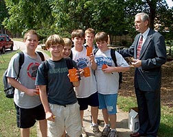 [Lee Warner passes out Youth Testaments at Martin Middle School.]