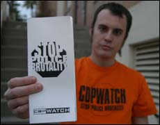 Political science junior Mike Kramer holds up a flier for Phoenix Copwatch, a local citizens activist group that has charged itself with the task of monitoring cops across the Valley.