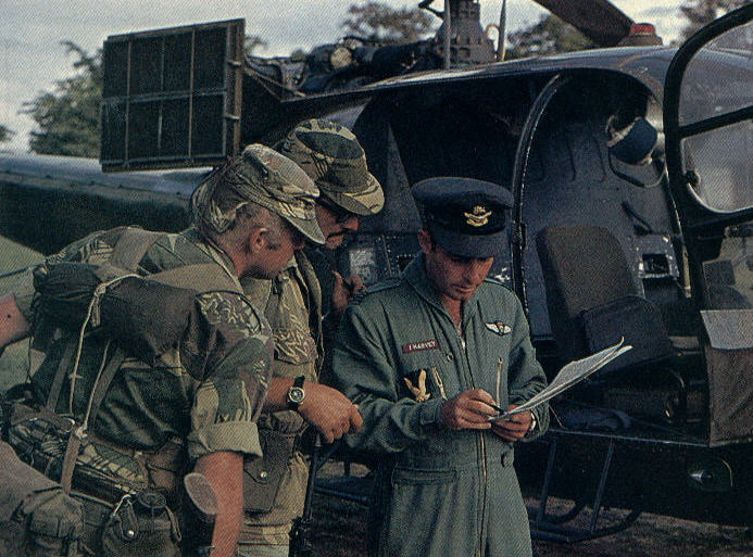 Scouts discuss dropoff points with Gazelle pilot prior to takeoff.