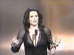 Megan Mullally, on stage, accepting her Emmy award
