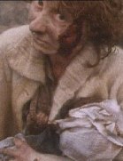 A disturbed woman, who sits in a devastated street, cradling her dead baby in her arms.  This is seen as part of a long sequence in which Ruth walks the streets and sees many aspects of the devastation.