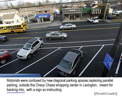 Motorists were confused by new diagonal parking spaces, replacing parallel parking, outside the Chevy Chase shopping center in Lexington, meant for backing into, with a sign so instructing (Herald-Leader)