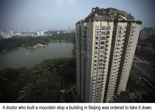 A doctor who built a mountain atop a building in Beijing was ordered to take it down