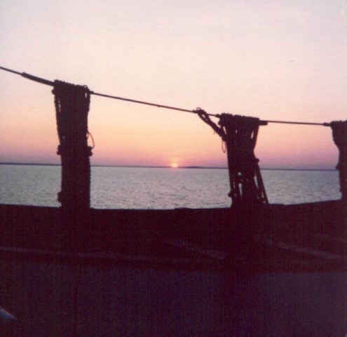 photo of sunset through the davits of a lifeboat
