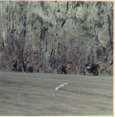 Image of our four bikes parked beside a rock wall on the road above Creede