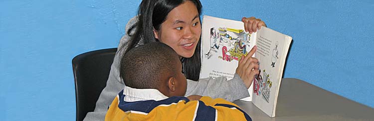 A student and tutor reading together