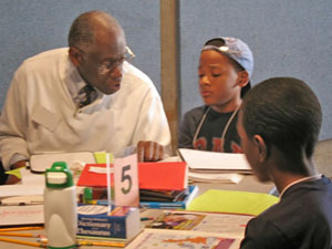 A community volunteer tutoring fifth graders.