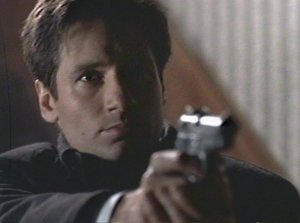 Once again Mulder points a gun at someone when he knows damn well he won't shoot. The sad thing is the person Mulder's pointing the gun at knows this as well.