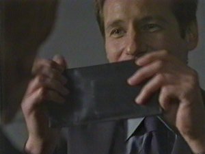 Mulder proudly displays his stolen treasure.