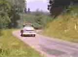 "Iron Clad Lou" video still of an old pickup truck & country road