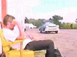 "Iron Clad Lou" video still of a gas station & attendant