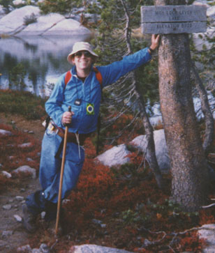 Larry pauses beside a trail marker high in the Sierra Nevada.  At peace with the world.