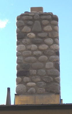 Closer image of a natural stone chimney.