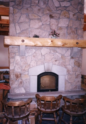 Photo of an oak trim fireplace.