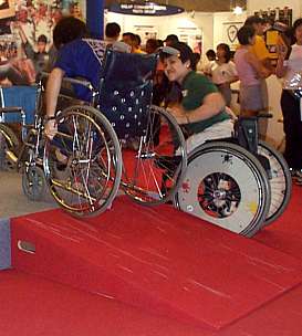 A visitor trying out wheelchair obstacles at the exhibition area