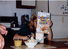 It's me!  The real me!  And my dad's hands reaching towards a banana-covered bowl of Wheaties.  Typical morning in Etoile's household.