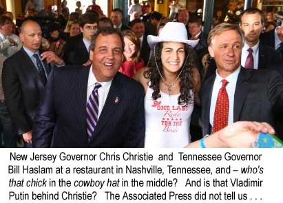 New Jersey Governor Chris Christie and Tennessee Governor Bill Haslam at a restaurant in Nashville, Tennessee, and – who's that chick in the cowboy hat between them? And is that Vladimir Putin behind Christie? The Associated Press did not tell us . . .