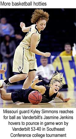Missouri guard Kyley Simmons reaches for ball as Vanderbilt's Jasmine Jenkins hovers to pounce in game won by Vanderbilt 53-40 in Southeast Conference college tournament