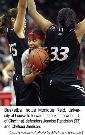 Basketball hottie Monique Reid, University of Louisville forward, sneaks between U. of Cincinnati defenders Jeanise Randolph (33) and Chelsea Jamison (Courier-Journal photo by Michael Clevenger)