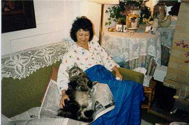 photo of my mom with our cat Fred reading the paper