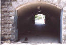 Looks out from the Park through the arched tunnel entrance to Bainbridge Ave and Van Cortlandt Ave East outside