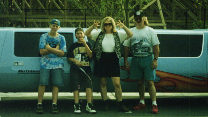 My brothers and my mom and dad standing in front of the "Mirthmobile" at King's Dominion.