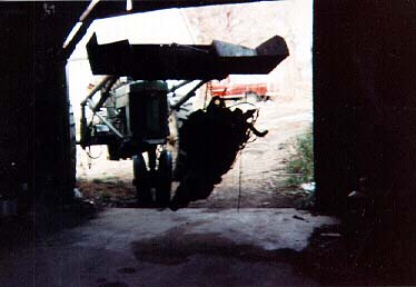 Dangling on the scoop of the 60 John Deere we bring one of GM's finest Big block engines and turbohydromatic transmissions into the shed for modifications. The 1970 Ford F250 4X4 is barely visible in the background