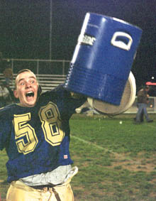 Central football player Ian Hess celebrates after splashing his coach