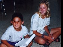 A counselor smiles as she and her student review his homework.