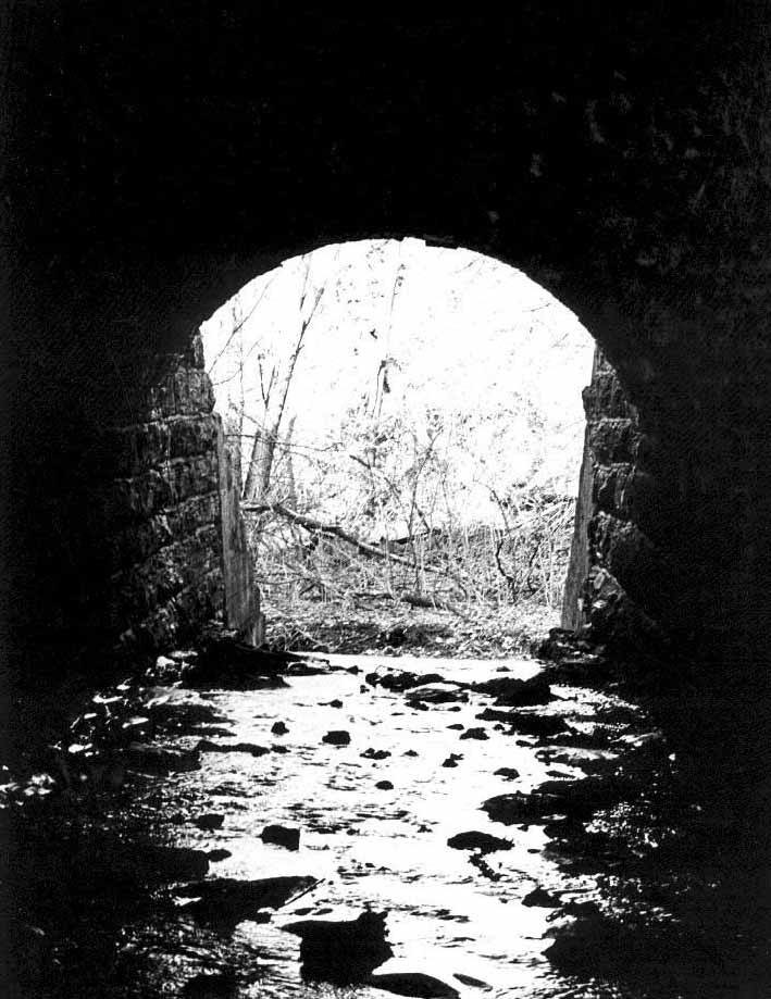 Tunnel for creek containing snow melt off in March under train tracks near Finkbine Golfcourse by the University of Iowa in Iowa City, Iowa.