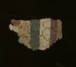 Mummy cartonnage fragment.  Its stucco/gesso outer layer is painted with a multicolored line decoration.