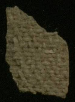 Cartonnage fragment constructed from linen.  This image shows the linen backing of the gesso outer layer.